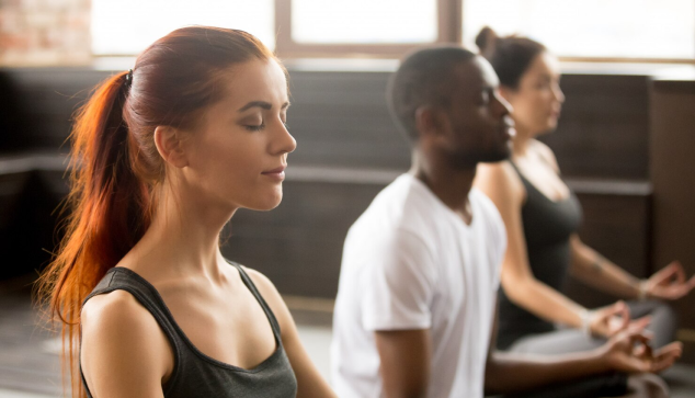 Group of people meditating.